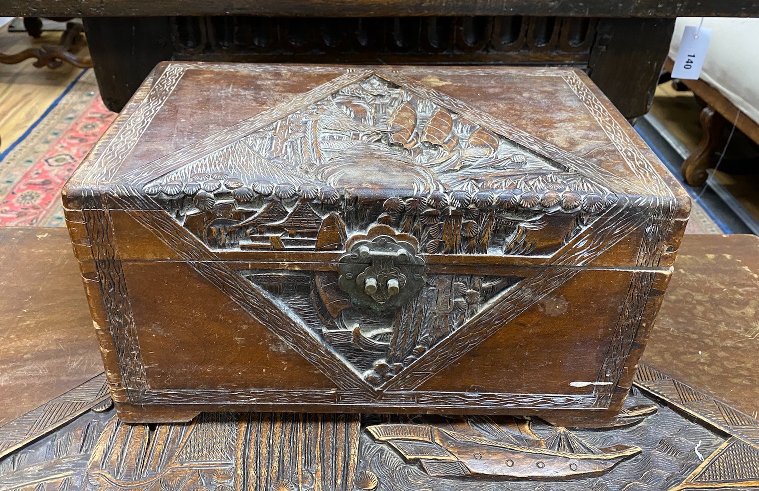 A Chinese carved camphorwood coffer and similar smaller box, larger length 93cm, depth 44cm, height 49cm